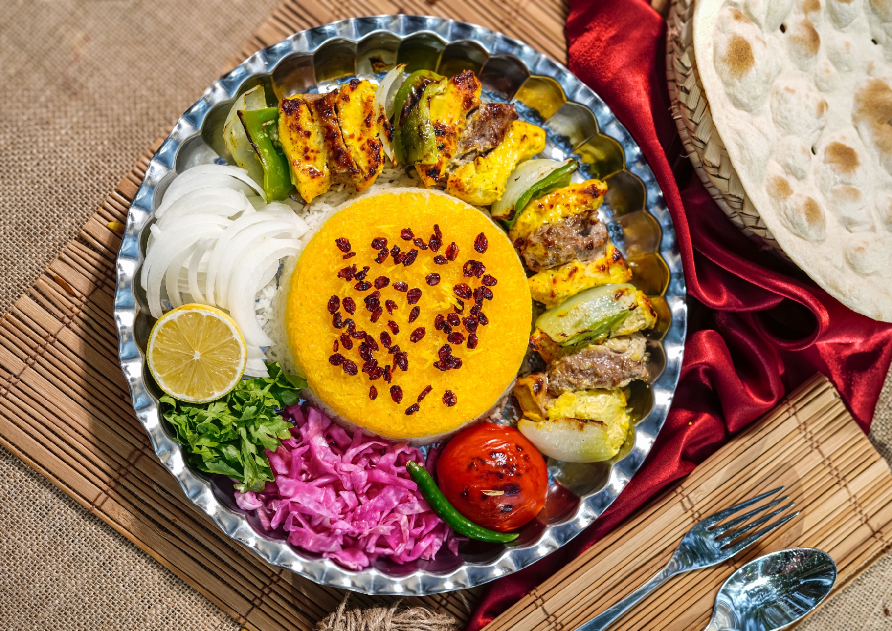Mixed skewers plated for two — koobideh and joojeh over rice